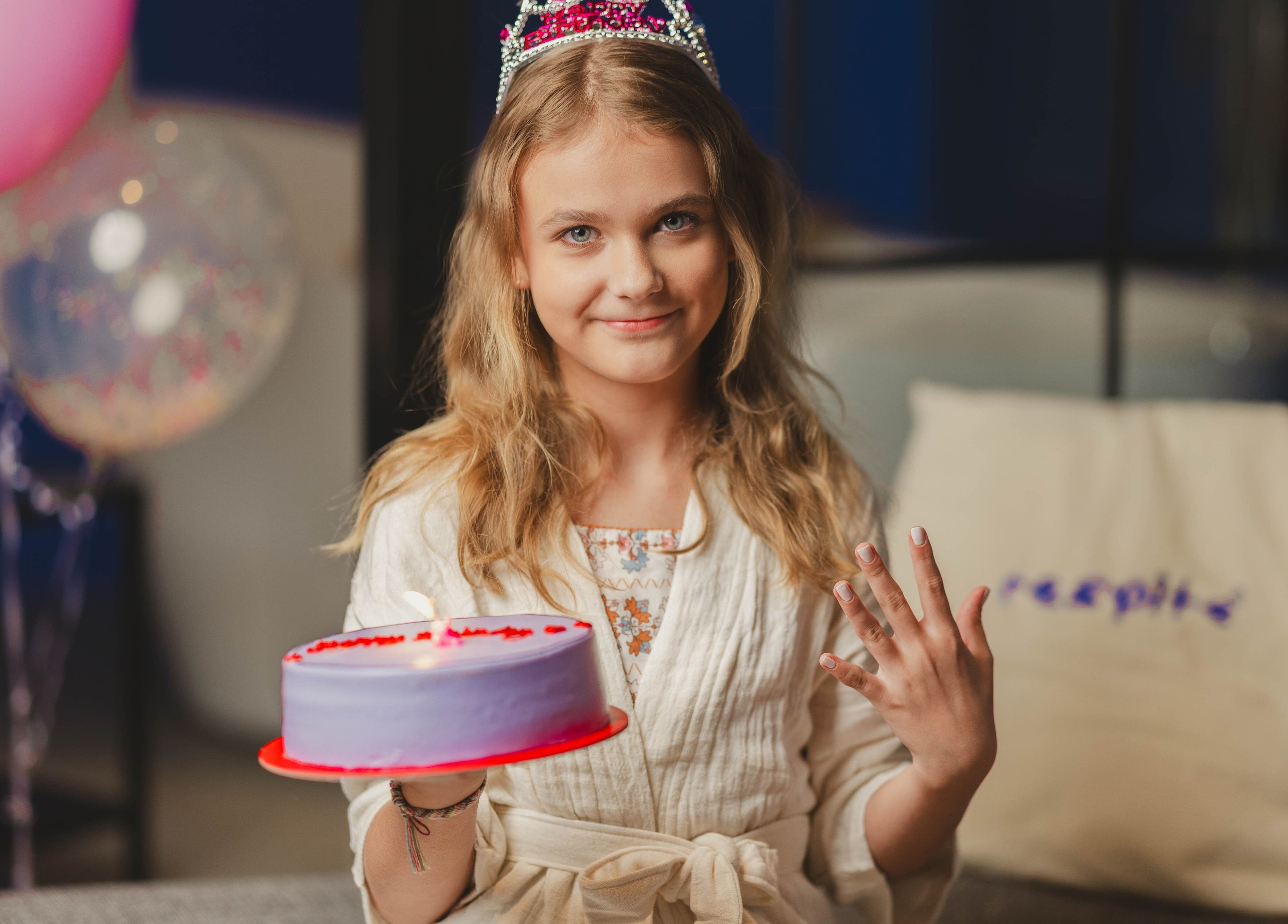 Young girl holding a birthday cake at Respite Care & Spa | Home Services, الرياض, منطقة الرياض, SA.