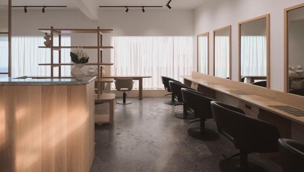 Stylish interior of Papillon Hair at Avalon Beach, New South Wales, AU, featuring sleek chairs and modern decor.