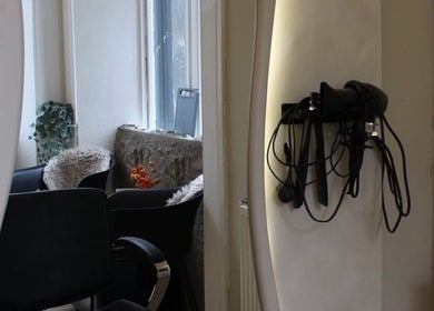 Cozy corner at Emily Louisa Hair, East Kilbride, Scotland, GB with styling tools and plush seating.