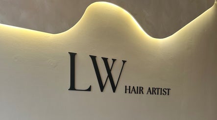 Modern wall signage of Emily Louisa Hair, East Kilbride, Scotland, GB with elegant lighting.