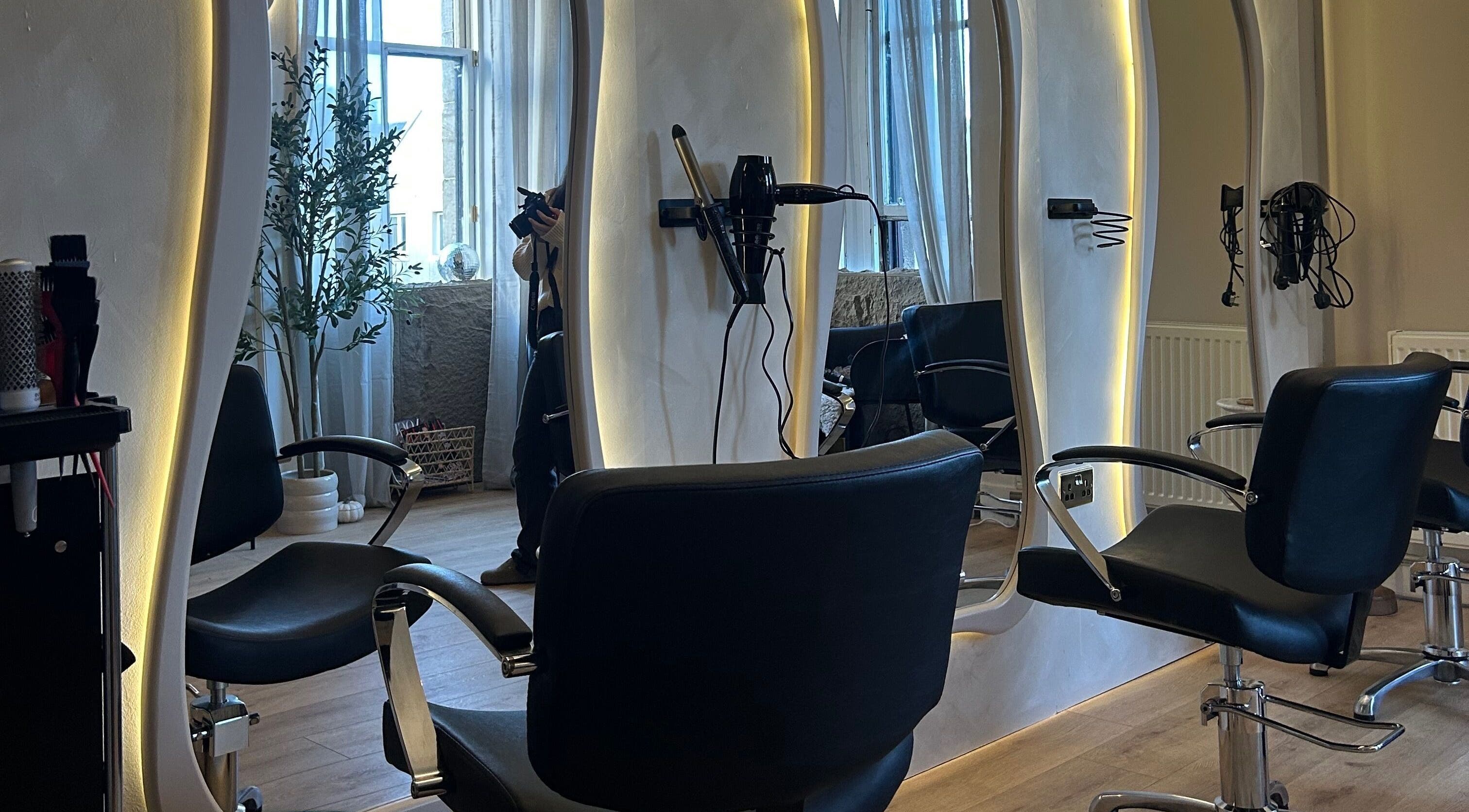 Modern styling chairs at Emily Louisa Hair, East Kilbride, Scotland, GB featuring sleek interior design.