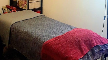 Cozy treatment room at Pupa Beauty Body Treatments in Weeting, England, GB with neatly arranged bed.