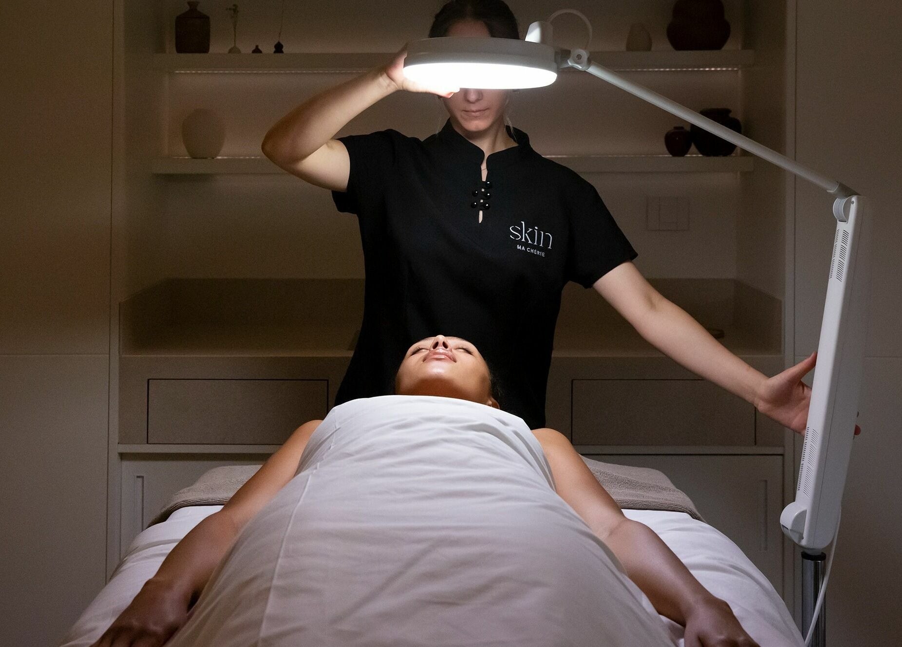 A relaxing facial treatment at Ma Cherie Skin, Αθήνα, GR. Aesthetician uses specialized light therapy.
