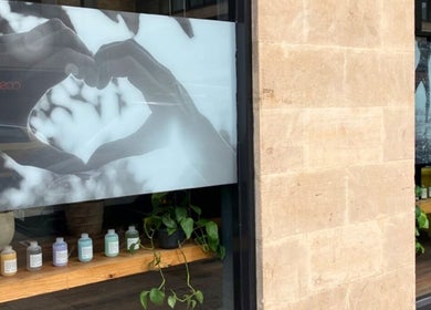 Window display at Beauty By Yasemin, Bristol, England, GB, showcasing heart design and wellness products.
