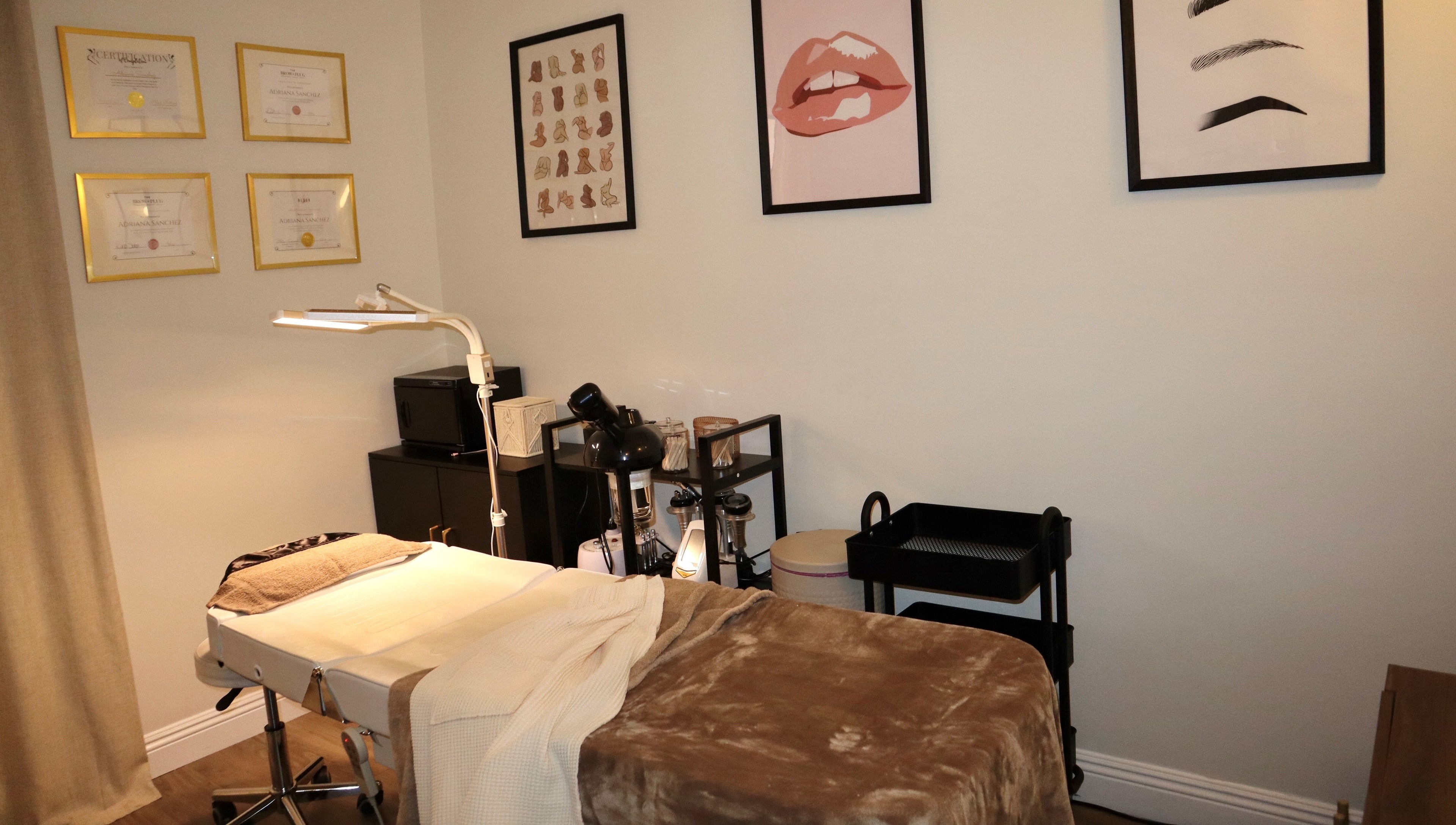 Relaxing treatment room at Haus of Allure, Phoenix, Arizona, US with stylish decor and massage bed.