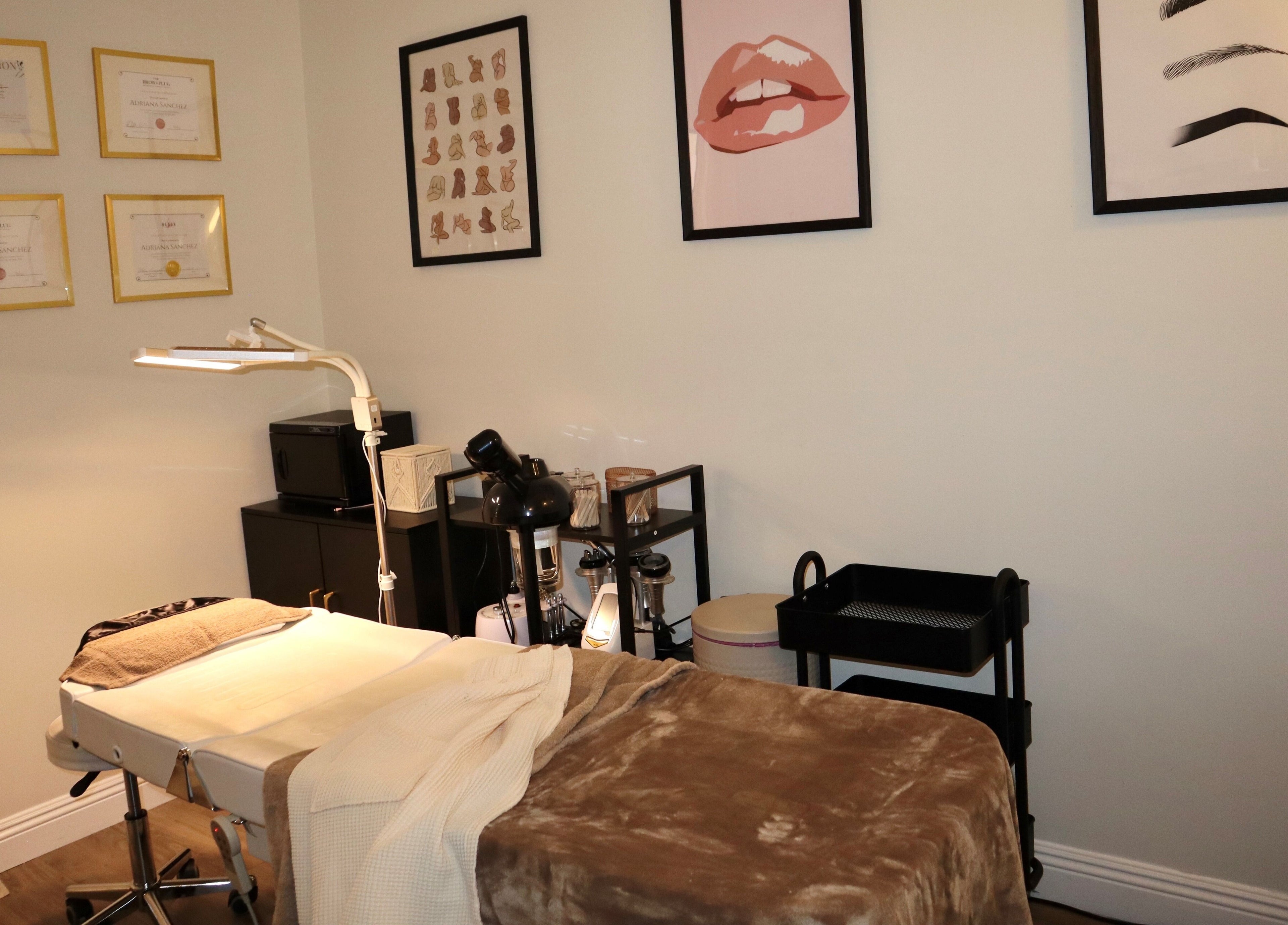 Relaxing treatment room at Haus of Allure, Phoenix, Arizona, US with stylish decor and massage bed.