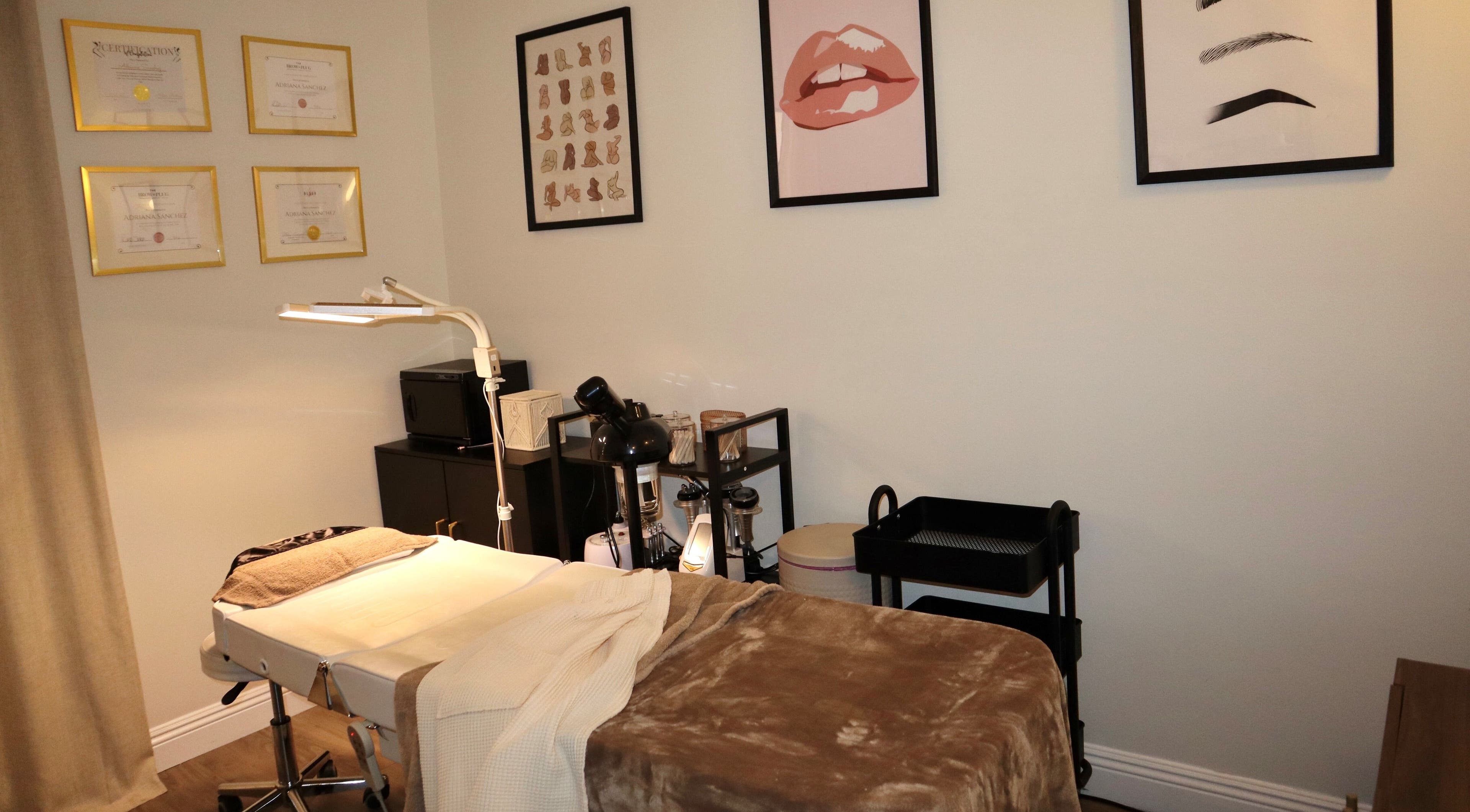 Relaxing treatment room at Haus of Allure, Phoenix, Arizona, US with stylish decor and massage bed.