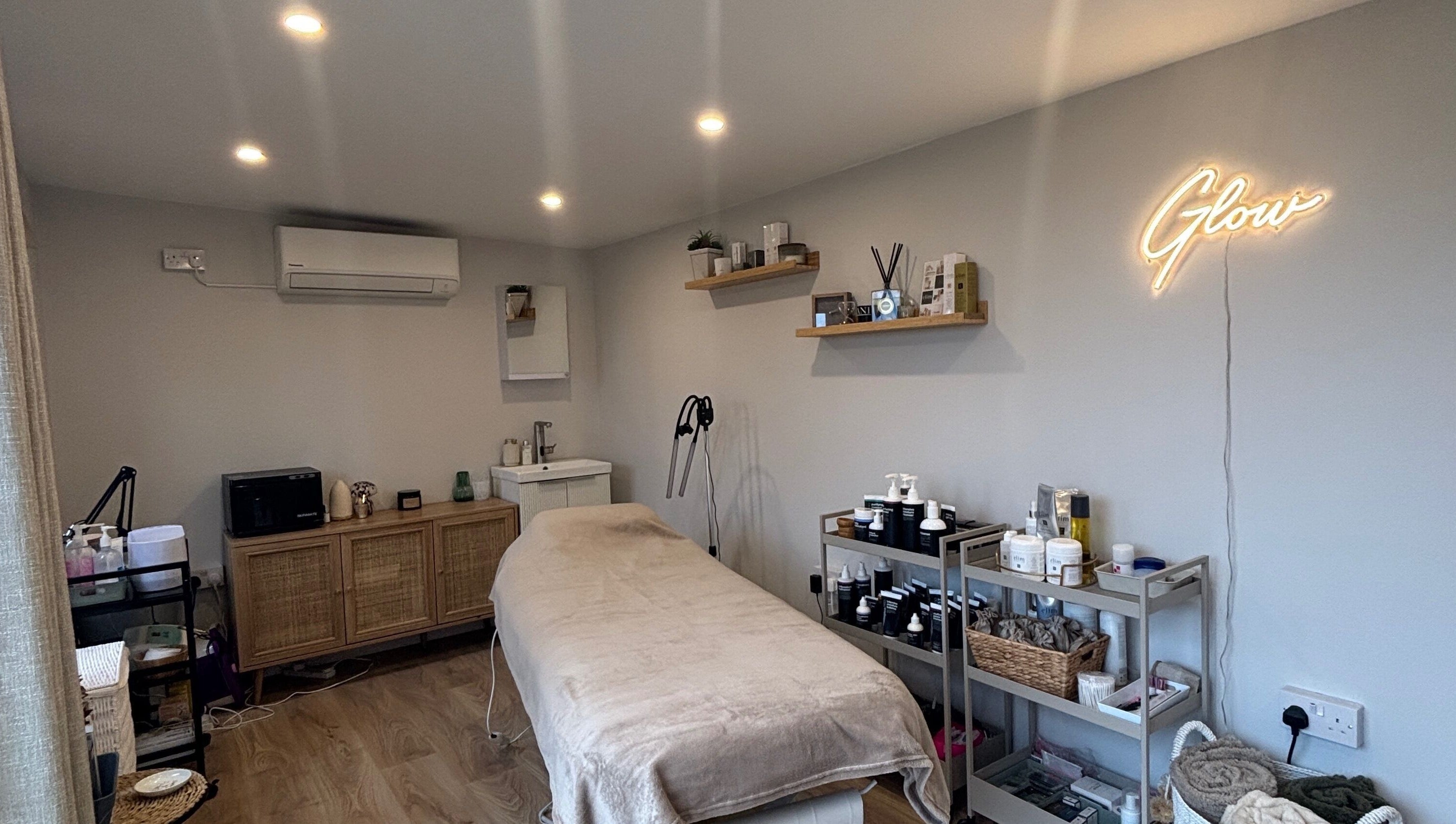 Calming treatment room at Glow by Hannah, Fordham, England, GB, featuring modern decor and wellness products.