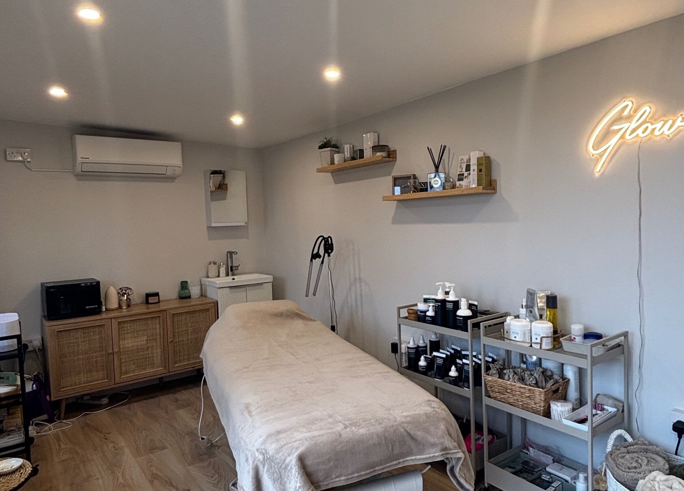 Calming treatment room at Glow by Hannah, Fordham, England, GB, featuring modern decor and wellness products.