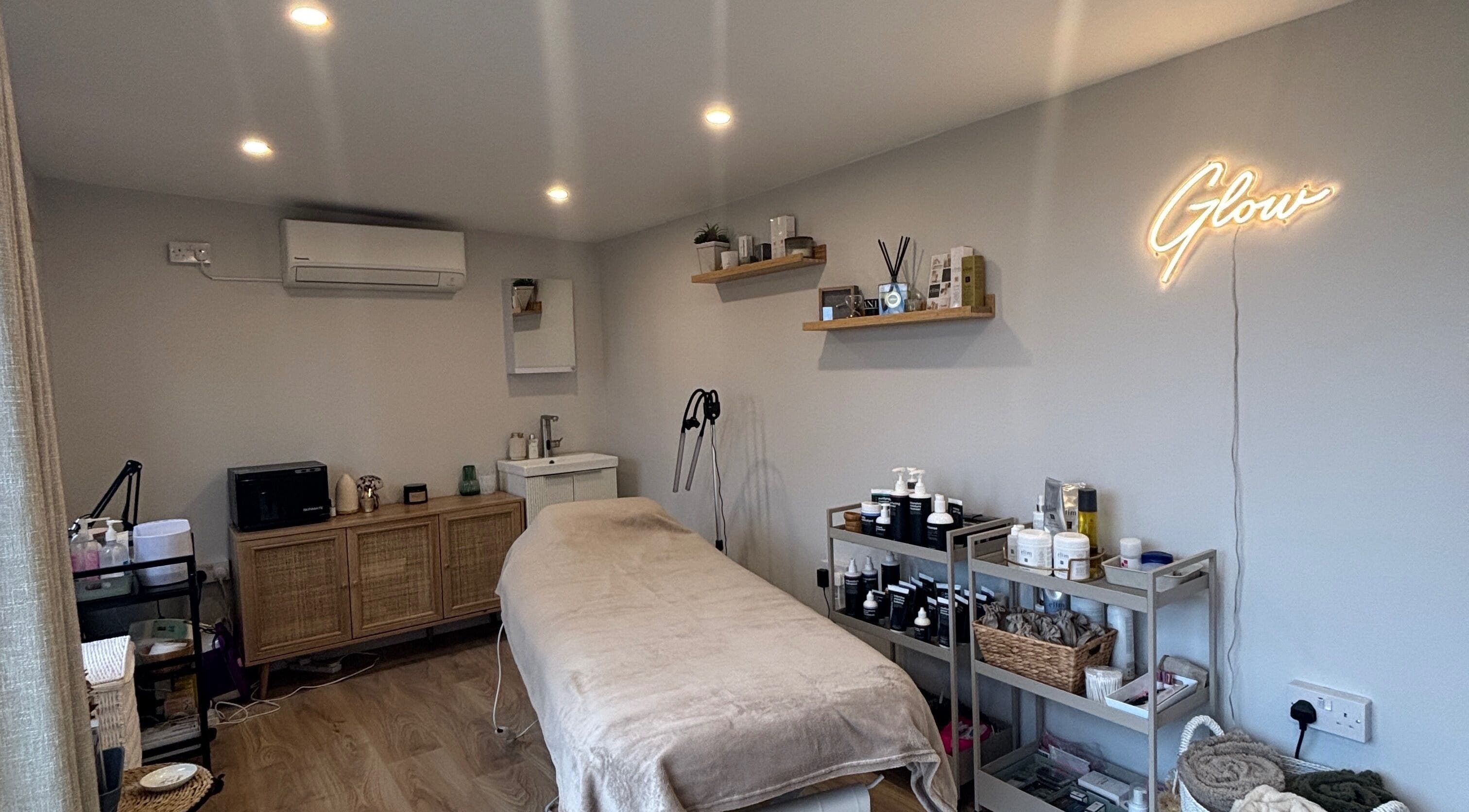 Calming treatment room at Glow by Hannah, Fordham, England, GB, featuring modern decor and wellness products.