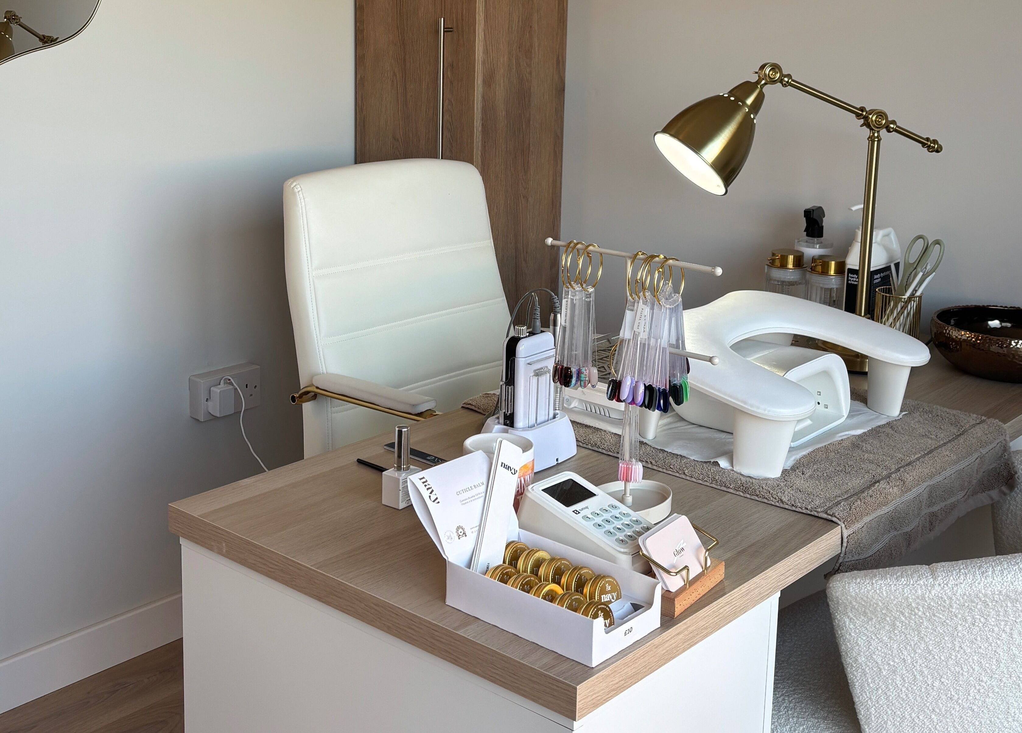 Luxurious nail salon setup at Glow by Hannah, Fordham, England, GB, featuring manicure tools and a chic lamp.