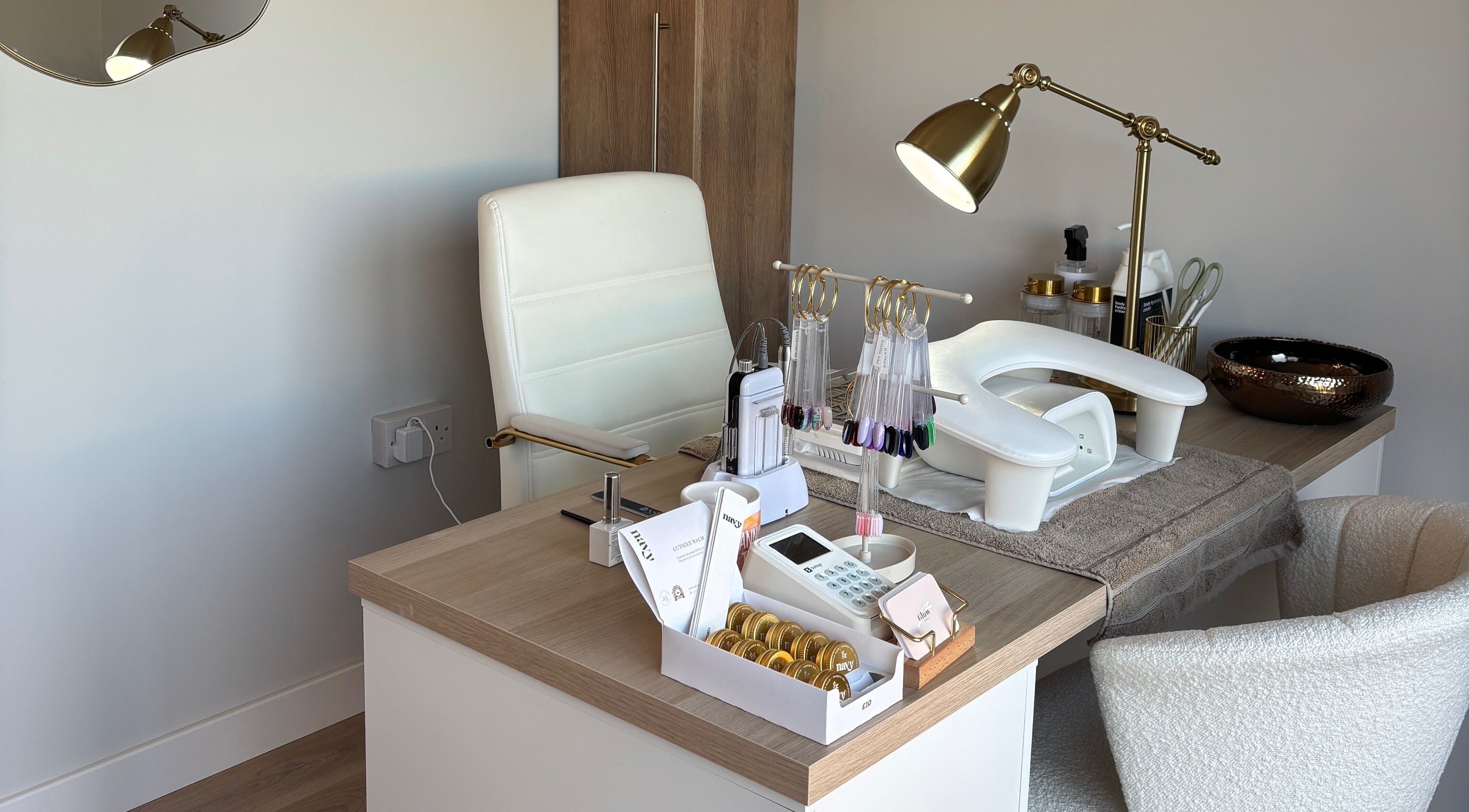 Luxurious nail salon setup at Glow by Hannah, Fordham, England, GB, featuring manicure tools and a chic lamp.