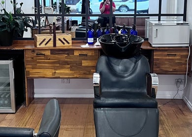 Modern salon setup at Be The Man Barber, Melbourne, Victoria, AU with stylish chair and wood counter.