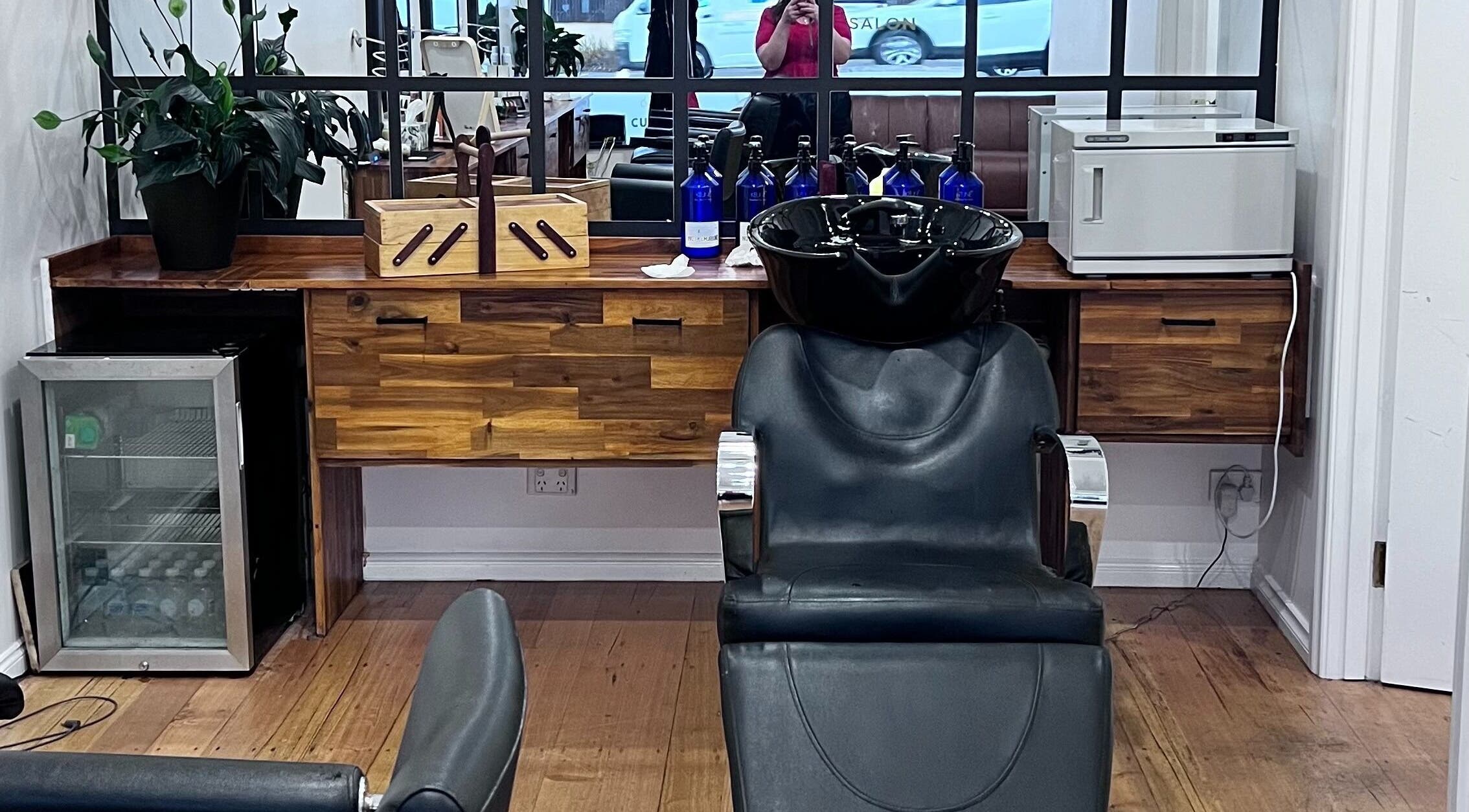 Modern salon setup at Be The Man Barber, Melbourne, Victoria, AU with stylish chair and wood counter.