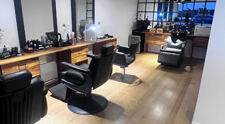 Modern interior of Be The Man Barber in Melbourne, Victoria, AU, showcasing sleek chairs and stylish decor.