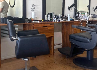 Interior of Be The Man Barber in Melbourne, Victoria, AU featuring modern chairs and grooming tools.