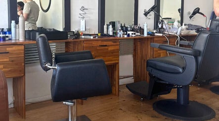 Interior of Be The Man Barber in Melbourne, Victoria, AU featuring modern chairs and grooming tools.