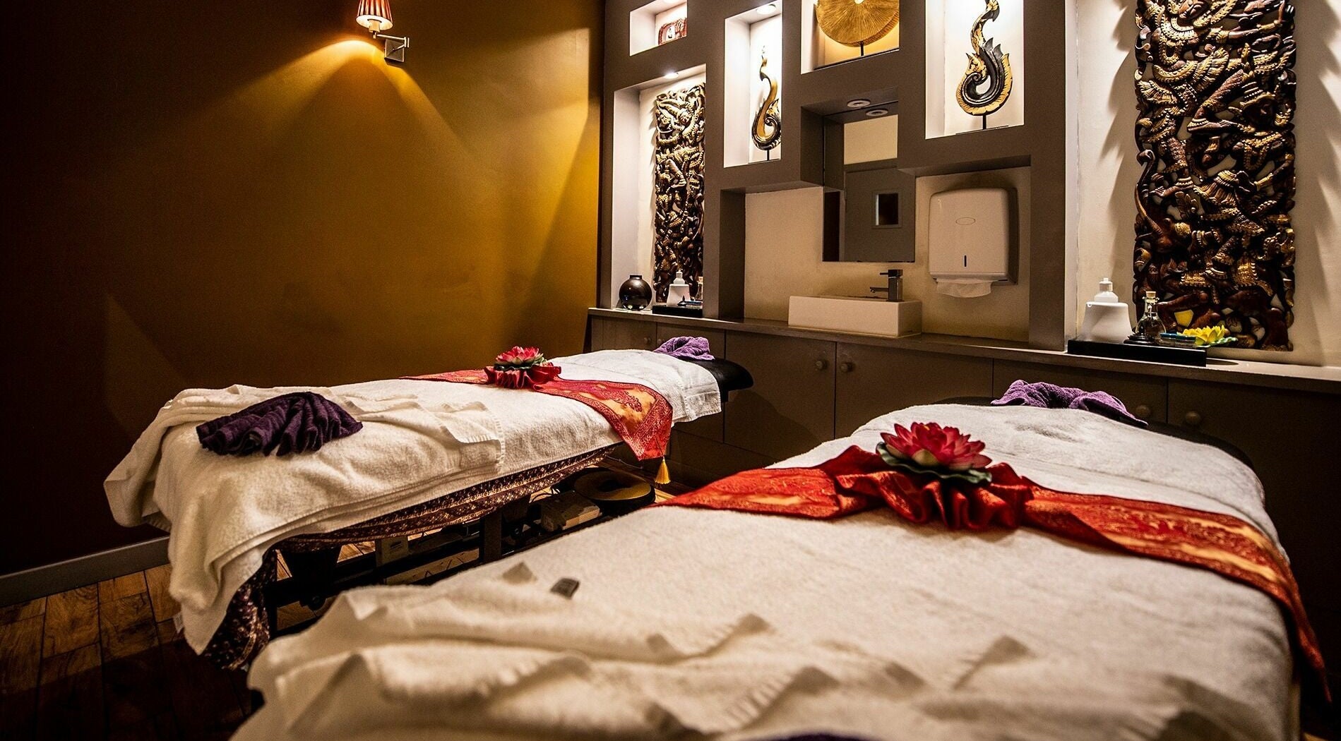 Luxurious massage room at King Thai Therapy Birmingham, England, GB, featuring two adorned massage tables.