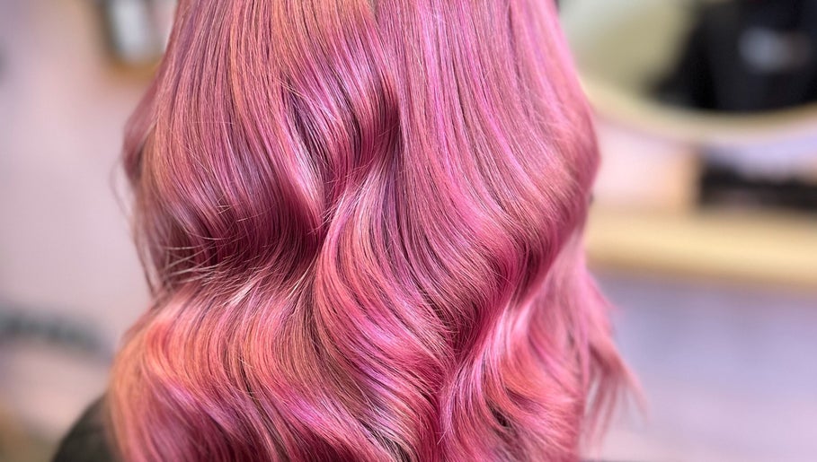 Vibrant pink wavy hairstyle at Hair by Lol, Birmingham, England, GB.