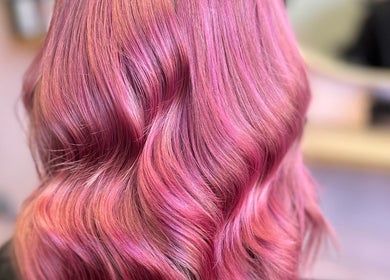 Vibrant pink wavy hairstyle at Hair by Lol, Birmingham, England, GB.