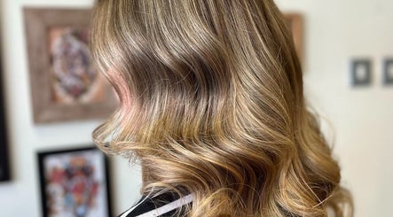 Stylish wavy blonde hairstyle at Hair by Lol, Birmingham, England, GB.