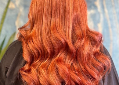 Vibrant red hair styled in waves at Hair by Lol, Birmingham, England, GB.