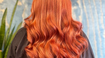 Vibrant red hair styled in waves at Hair by Lol, Birmingham, England, GB.