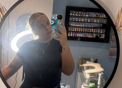 Mirror selfie at Miss Miss Beauty, Cambuslang, Scotland, showcasing makeup shelves and ring light glow.