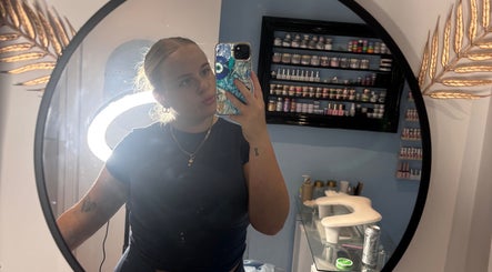 Mirror selfie at Miss Miss Beauty, Cambuslang, Scotland, showcasing makeup shelves and ring light glow.