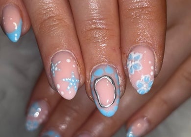 Elegant floral nail art at Miss Miss Beauty, Cambuslang, Scotland, GB. Mix of pastels and intricate designs.