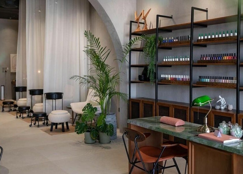 Modern interior of Dry by Spa in Riyadh, SA featuring nail polish displays and elegant seating areas.