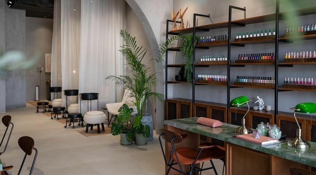 Modern interior of Dry by Spa in Riyadh, SA featuring nail polish displays and elegant seating areas.