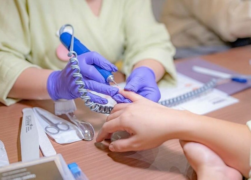 Professional nail care at Dry by Spa, Riyadh, SA, highlighting precision and detail in a wellness setting.