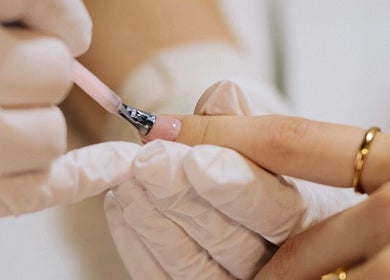 Nail technician applying polish at Set Studio, Manchester, GB.
