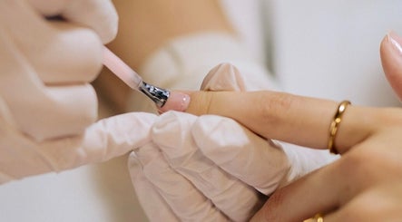 Nail technician applying polish at Set Studio, Manchester, GB.