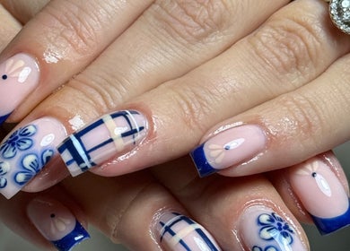 Elegant blue floral nail art from Haus of Rayah in Prestwich, England, GB. Perfect for beauty enthusiasts.