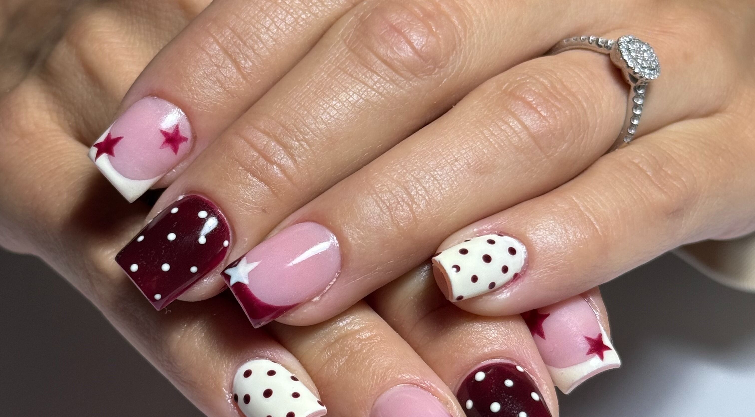 Starry maroon nail art at Haus of Rayah, Manchester, England, GB. Stylish and unique manicure design.