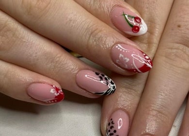 Elegant nail art at Atelier in Stockton-on-tees, England, GB, featuring intricate designs with red and black accents.