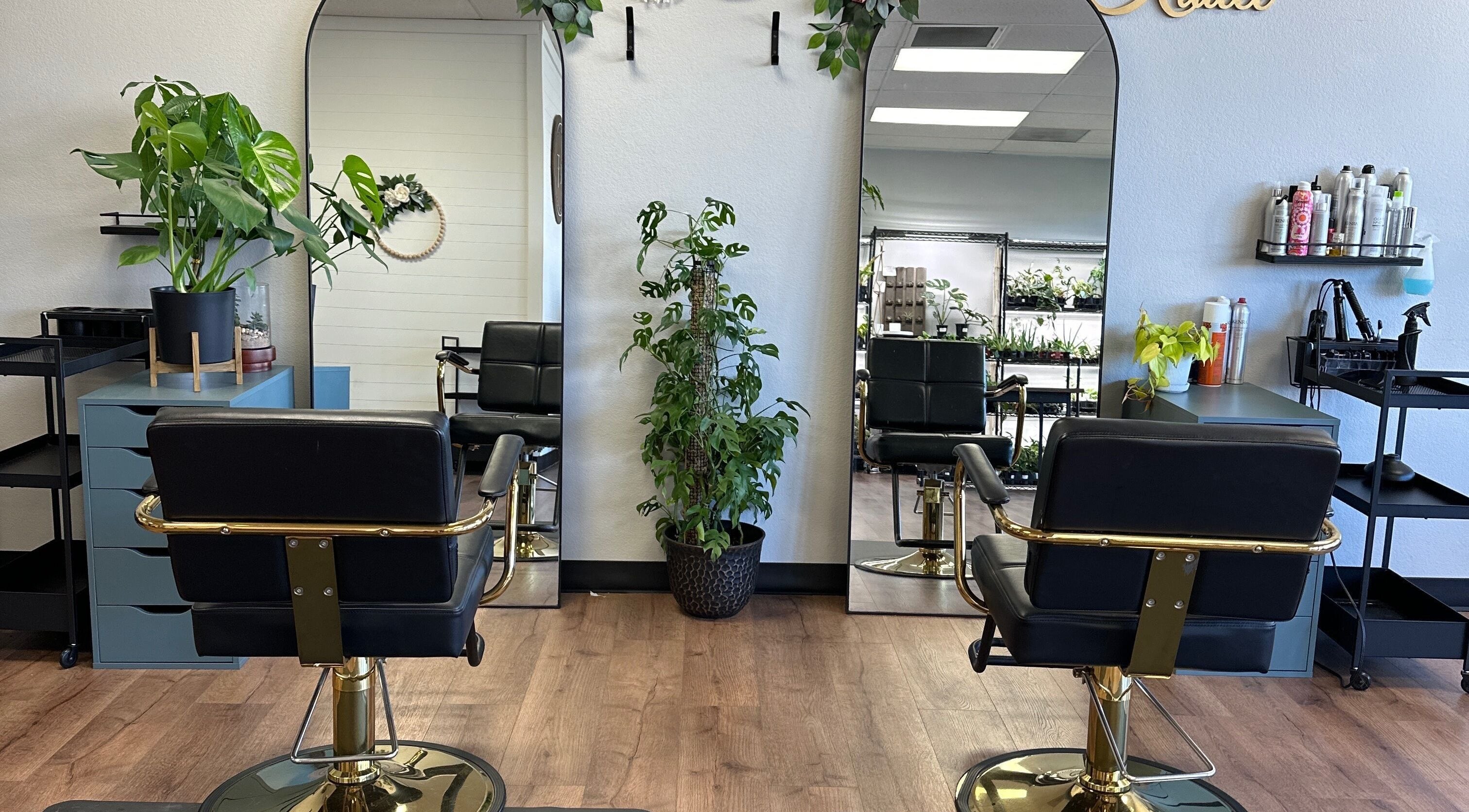 Modern salon chairs and mirrors at Foils and Fades Hair Company in Mccleary, Washington, US.