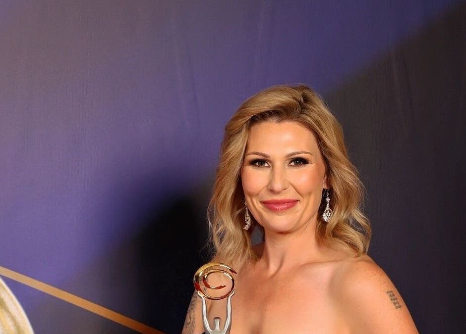 Elegant setting at La Chay Studio, Mansfield, Victoria, AU with a guest holding an award.