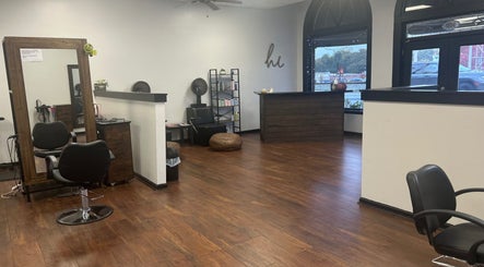 Stylish interior of The Upper Cut Salon in Villa Rica, Georgia, US, featuring modern chairs and wooden flooring.