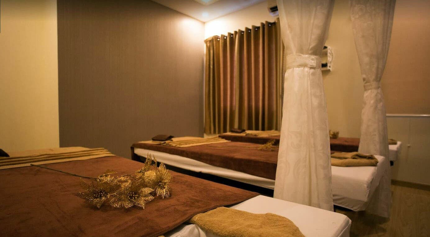 Relaxing massage room at Silk Spa with warm tones and privacy curtains in Đà Nẵng, Đà Nẵng, VN.