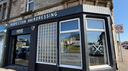 Perfection Hairdressing storefront in Kirkcaldy, Scotland, GB, showcasing sleek modern design.