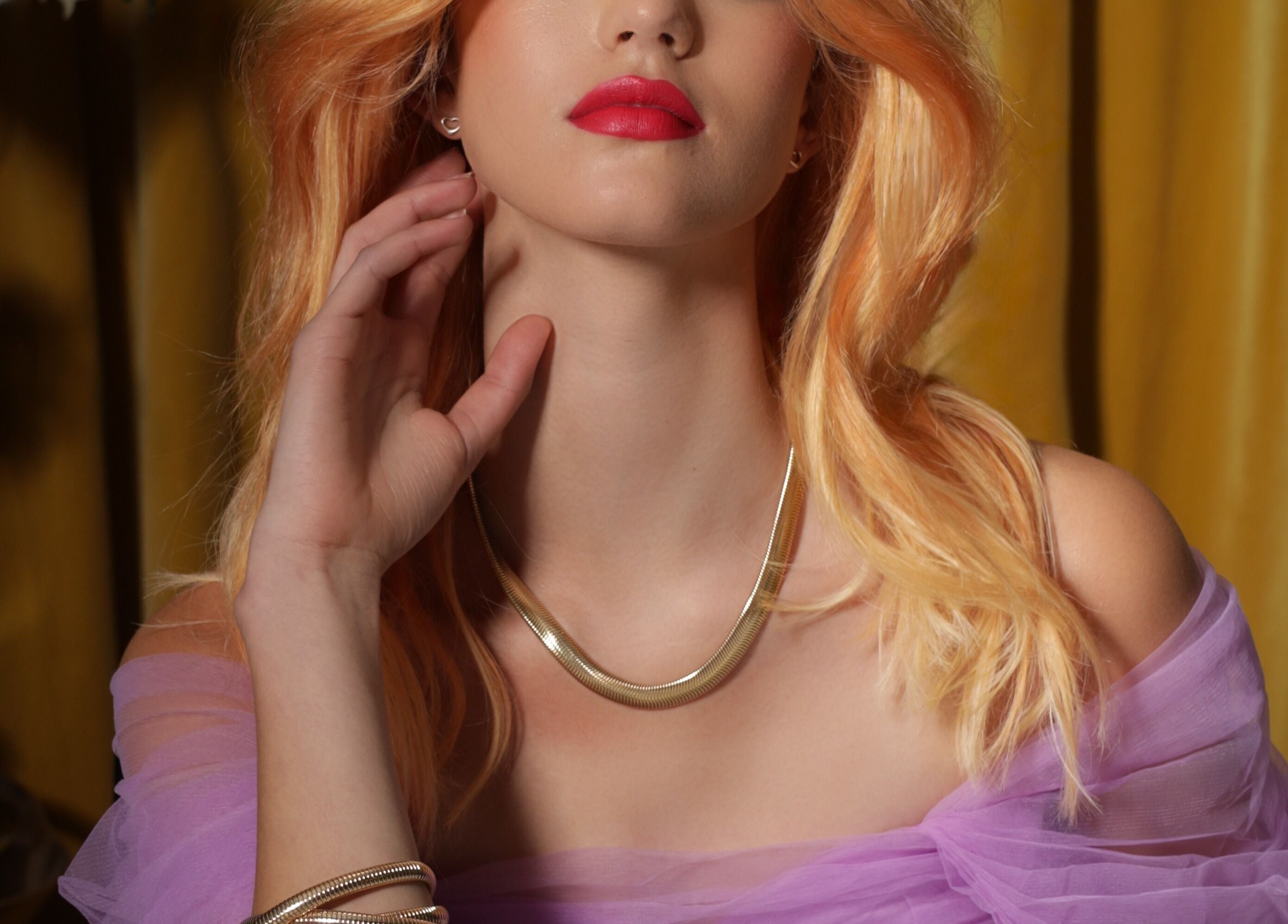 Elegant woman with striking necklace and red lipstick at Studio 2 Brighton, Brighton And Hove, England, GB.
