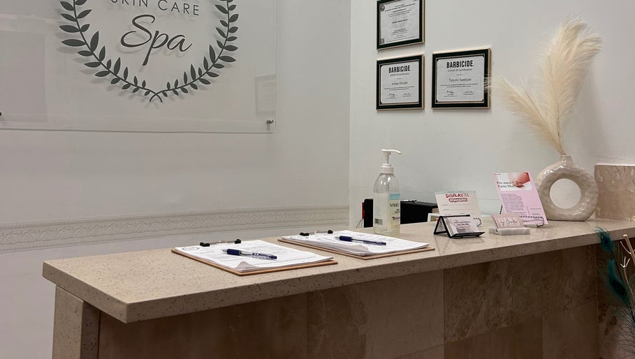 Reception desk at Wilma Skin Care, Coconut Creek, Florida, US, featuring certification and decor.