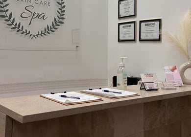 Reception desk at Wilma Skin Care, Coconut Creek, Florida, US, featuring certification and decor.