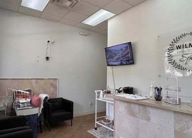 Interior of Wilma Skin Care in Coconut Creek, Florida, US, featuring a cozy seating area and a modern reception desk.