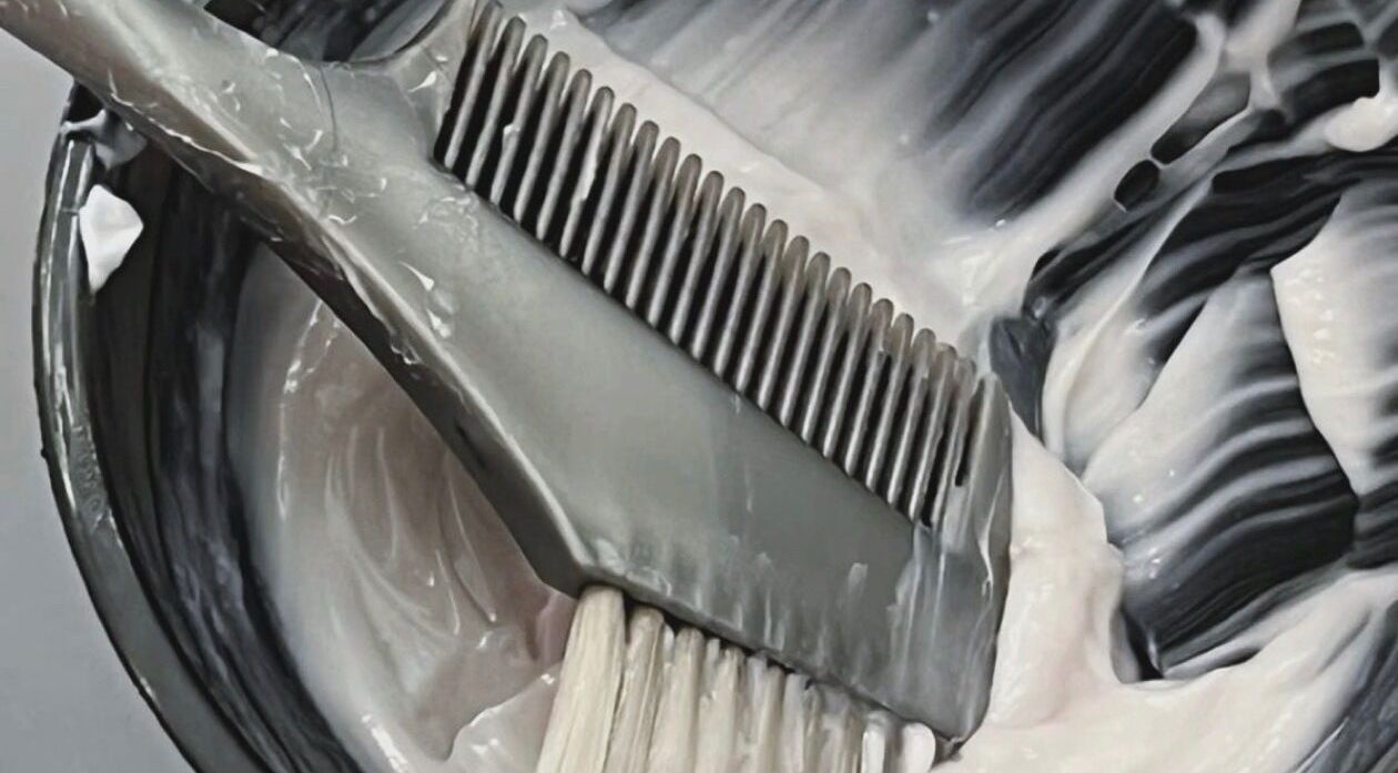 Hair dye brush in creamy color at Root & Remedy, Southampton, England, GB.