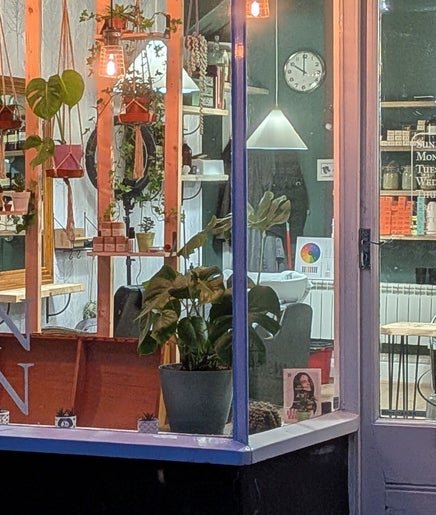 Inviting front view of The Eco Green Salon in Ulverston, England, GB, showcasing plants and eco-friendly decor.
