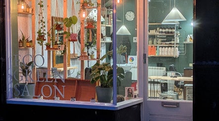 Inviting front view of The Eco Green Salon in Ulverston, England, GB, showcasing plants and eco-friendly decor.